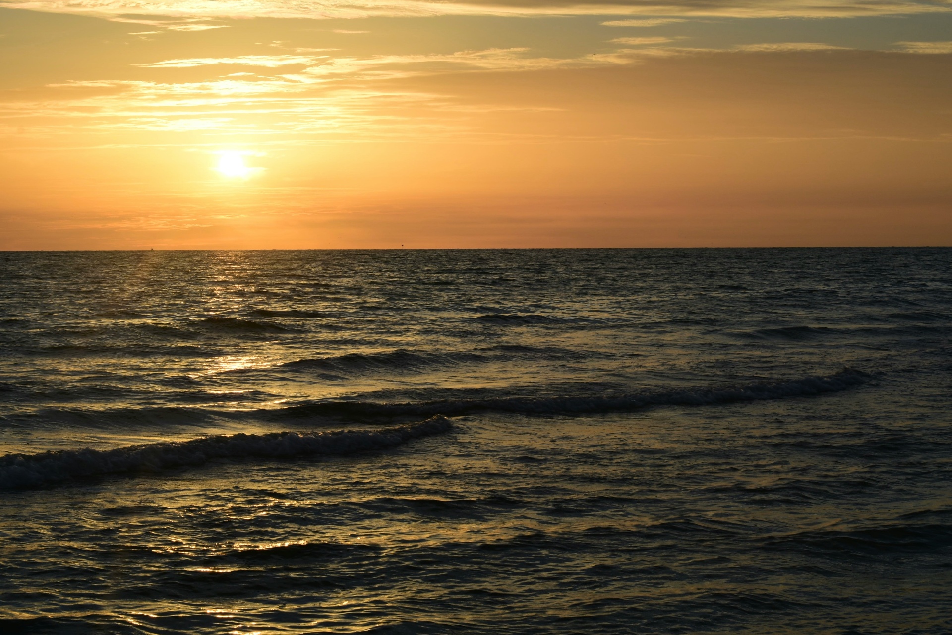 Sunset glowing over gentle waves on the Gulf of Mexico